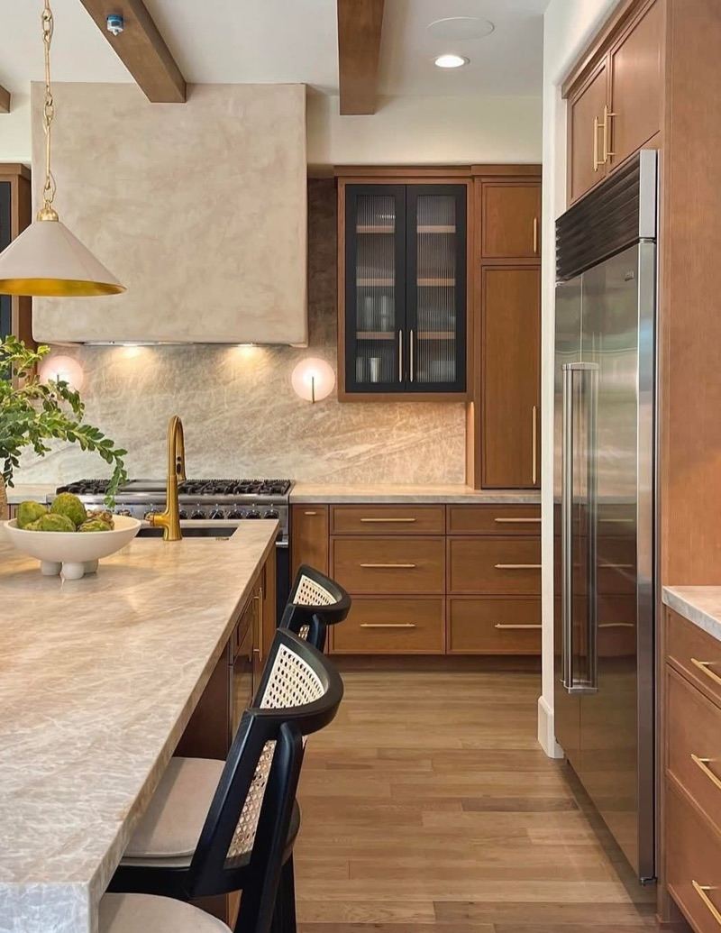 Stained oak kitchen cabinetry with stone backsplash built by Birch & Grain